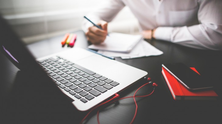 An image of person working at a laptop with a notepad | IT Services in Falkirk